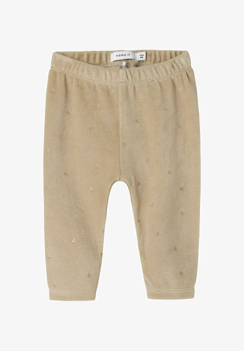 Leggings per infantini beige realizzati in un morbido tessuto con una superficie testurizzata. Presentano motivi di stelle dorate e una vita elastica per il comfort.