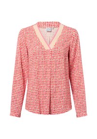 Bluzka z długim rękawem w jasnoróżowym kolorze z geometrycznym wzorem w ciemniejszym różu i czerwieni. Ma dekolt w kształcie litery V i luźny krój.