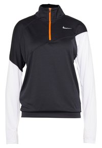 Mustan ja valkoisen pitkähihainen pullover, jossa neljännesvetoketju ja oranssi yksityiskohta. Hopeinen Nike-logo rinnassa. Pehmeä kangas.