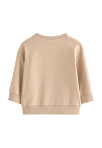 Sweatshirt beige court avec un col rond, des épaules tombantes et des poignets côtelés. Texture lisse, design minimaliste sans ornements.