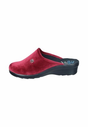 Red velvet clogs with a black rubber sole, featuring a curved design and a small logo accent on the side. Smooth texture and slip-on style.