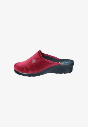 Red velvet clogs with a black rubber sole, featuring a curved design and a small logo accent on the side. Smooth texture and slip-on style.