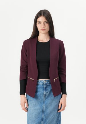 Burgundy blazer with long sleeves, front zippered pockets, open front design, paired with a black top and denim skirt. Smooth texture.