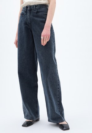 Wide-leg dark denim jeans with a high waist, five pockets, and a classic blue tone. Smooth texture with subtle stitching details.