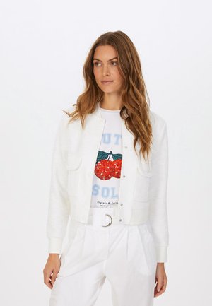 White textured bomber jacket with a ribbed collar and cuffs, featuring two front pockets and snap-button closure over a graphic t-shirt.