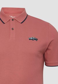 Stofroze polo shirt met zwarte bies op de kraag en mouwen, voorzien van twee knopen en een kleine geborduurde zwarte auto op de borst.