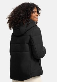 Black puffer jacket with a hood, featuring a quilted design and zippered side pockets. Smooth texture, versatile for various weather conditions.
