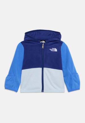Veste polaire à capuche pour enfants en bleu foncé, bleu clair et bleu ciel avec fermeture éclair devant et logo The North Face sur la poitrine.