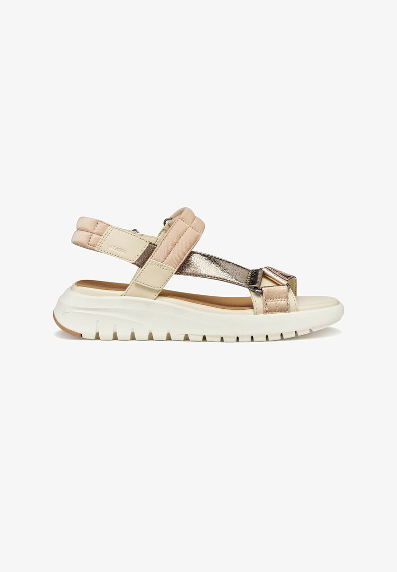 Strappy sandal in light beige and metallic tones; features a cushioned footbed, textured outsole, and adjustable straps for fit.