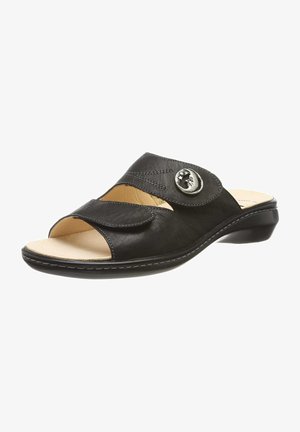 Black leather slide sandal with a rounded toe, open design, adjustable strap, decorative silver button, and low heel. Soft inner lining.