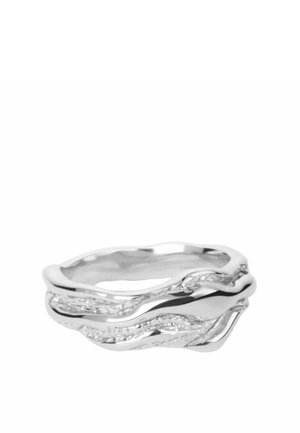 Bague en argent avec un design superposé ondulé présentant des surfaces lisses et texturées pour un look moderne et organique.