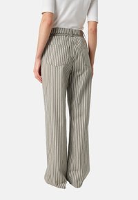 Striped wide-leg trousers in muted green and white. Features a high waistband, two back pockets, and a relaxed fit.