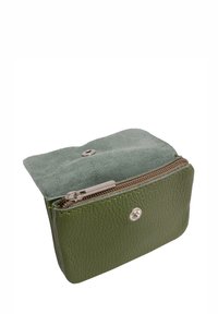 Portefeuille en cuir vert avec une finition texturée, fermeture zippée et un rabat en suède vert doux. Comprend des quincailleries en argent et un détail de logo.