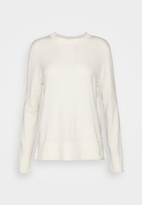 Pull à manches longues de couleur crème avec un col rond, des poignets côtelés et un ourlet droit. Tissu doux à la texture lisse.