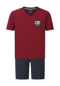 Red cotton t-shirt with navy V-neck and short sleeves, featuring a graphic design with "1984" and a flag, paired with navy shorts.