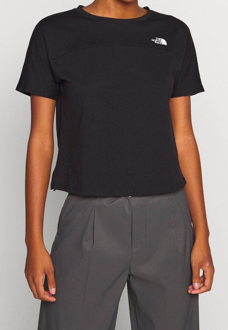 Mustat lyhythihaiset T-paidat, jotka on valmistettu kevyestä kankaasta, pyöreä kaula-aukko ja valkoinen logo vasemmassa yläkulmassa. Lyhennetty malli.