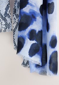 Blue and black patterned scarf featuring a mix of abstract shapes and a fringe bottom, made of lightweight fabric with a soft texture.
