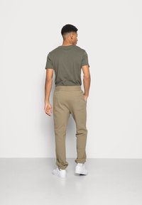 ARKET Calças de fato de treino - khaki green