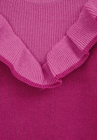 Pink knitted sweater featuring a ribbed texture with a ruffled neckline, transitioning from a lighter to a darker shade of pink.