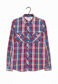 Camicia a maniche lunghe a quadri con motivi a check blu, rosso, arancione e giallo, dotata di due tasche sul petto e dettagli con bottoni.