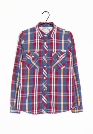 Kostkovaná košile s dlouhými rukávy v modrých, červených, oranžových a žlutých tónech, se dvěma kapsami na hrudi a knoflíkovými detaily.