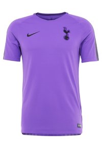 Purple Nike jersey featuring short sleeves, a crew neck, and a black Tottenham Hotspur emblem on the chest. Textured mesh detail on sleeves.