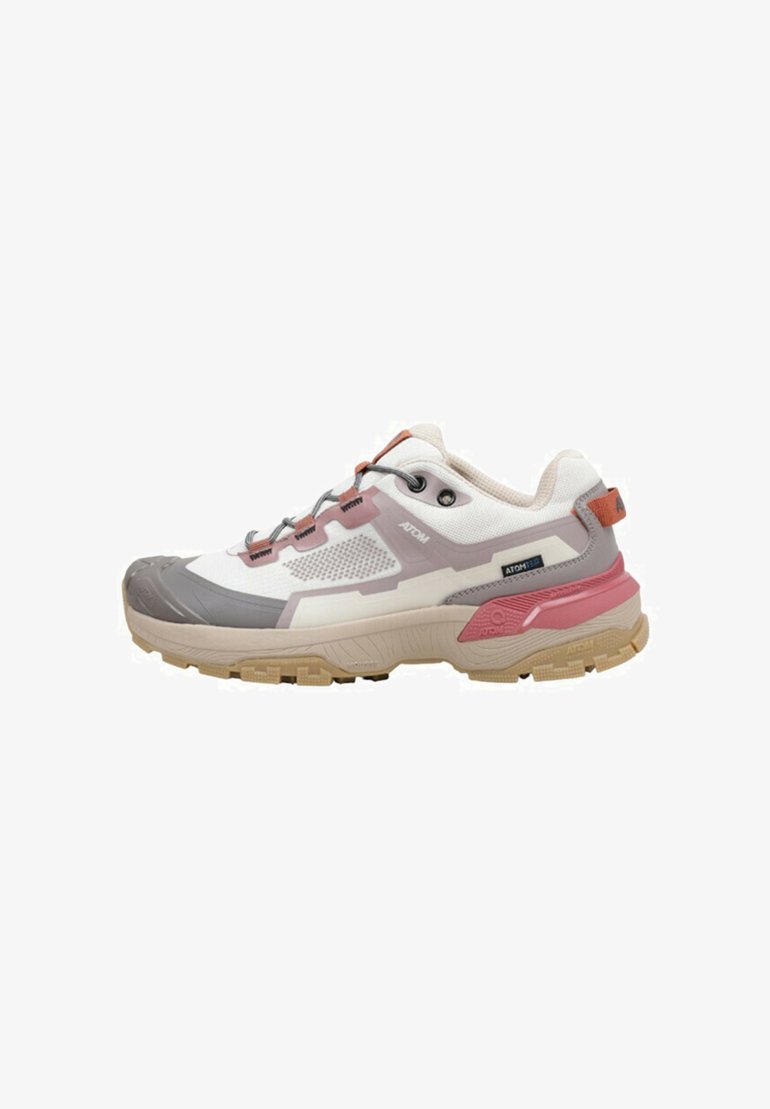 Zapatilla deportiva ligera con una parte superior blanca y gris, acentos en rosa, paneles de malla texturizada y una suela resistente en color beige. Presenta cordones elásticos.