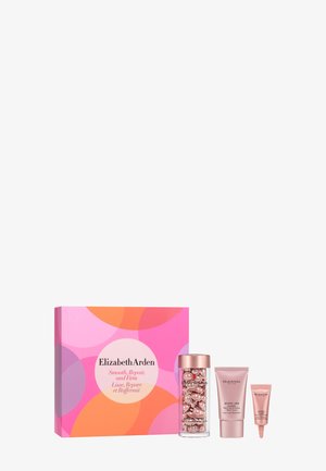 Coffret soin de la peau Elizabeth Arden avec boîte colorée rose et orange, un pot de capsules, un tube rose et un petit contenant de crème rose.