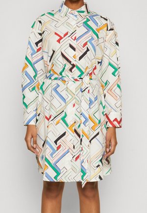 White belted shirt dress with long sleeves featuring a multicolored geometric maze pattern in red, green, blue, yellow, and black.
