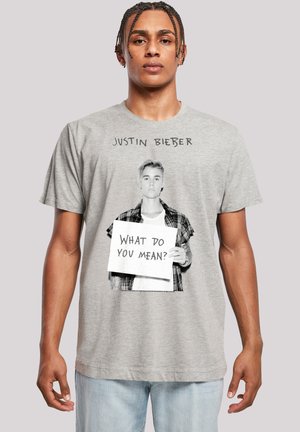 Gray cotton t-shirt featuring a black and white graphic of a person holding a sign with "What Do You Mean?" text above, designed with casual fit.