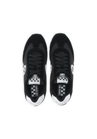 Black sneakers with a mix of suede and mesh, featuring round laces, checkered insoles, and white accents on the heel and branding.