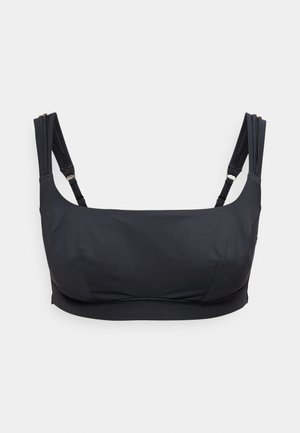 Crop top noir à encolure carrée avec double bretelles réglables sur un fond clair uni.