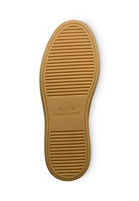 Gummischuhsohle in Beige mit horizontalen und vertikalen Rillen für Grip, mit dem eingeprägten Text "ALLEN EDMONDS" in der Nähe der Ferse.
