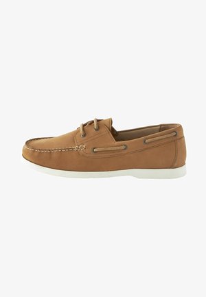 Brown leather boat shoe with a sleek design, white rubber sole, thin lacing, and stitching detail along the edge.