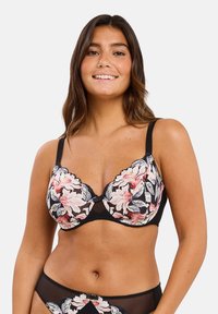 Sujetador negro con bordado floral en rosa, crema y verde. Con borde de encaje y un detalle de lazo en el centro frontal, con tirantes ajustables.