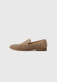 Suede loafers in light brown with a stitched design, flat sole, and open sides for easy slip-on access. Rubber outsole for durability.