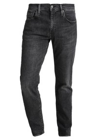 Svart urtvättade slim-fit jeans med midjeband, knapp fram, dragkedja, bältesöglor och femficksdesign.