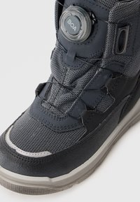 Czarno-szare sportowe buty z teksturowaną cholewką z tkaniny, systemem zamknięcia BOA oraz gumową podeszwą z wzmocnioną czubkiem.