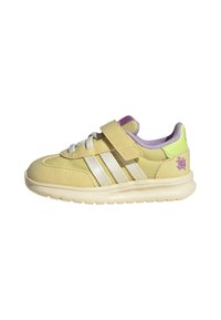 Yellow suede sneaker with three white stripes, Velcro strap, and light purple accents. Lightweight sole and padded collar for comfort.