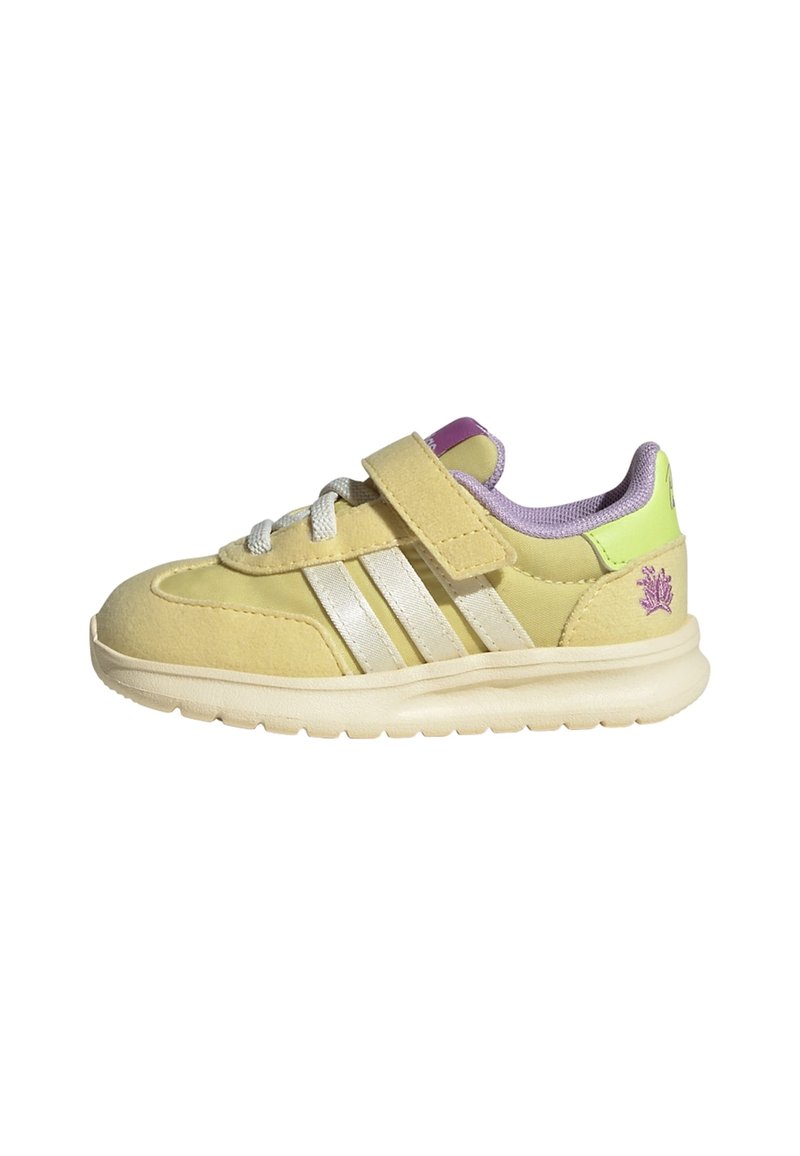 Yellow suede sneaker with three white stripes, Velcro strap, and light purple accents. Lightweight sole and padded collar for comfort.