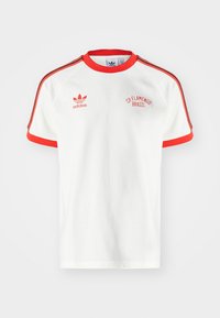 White Adidas T-shirt with red trim, red three stripes on sleeves, Adidas logo on left chest, and "CR Flamengo Brasil" text on right chest.