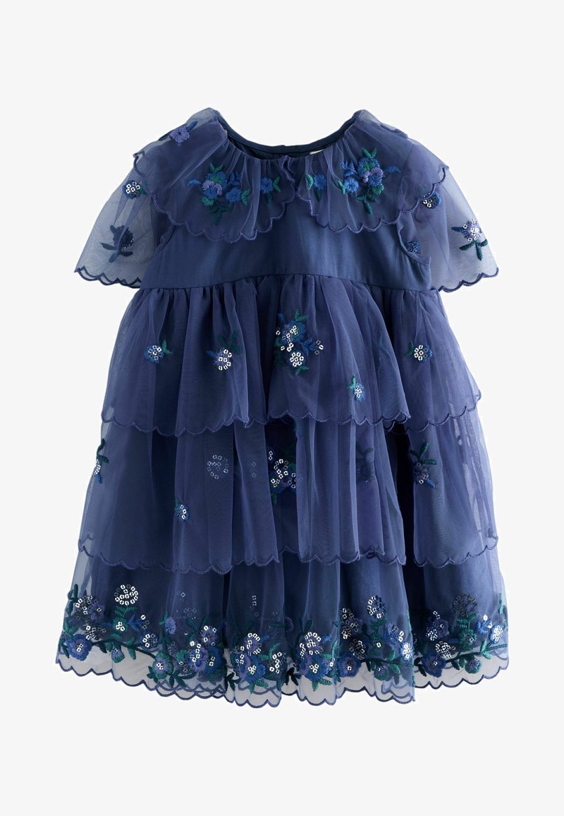 Abito in tulle a strati di colore blu navy con bordi ondulati e motivi floreali ricamati in tonalità di blu, bianco e verde.