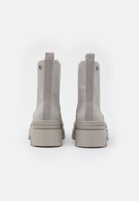 Gray suede ankle boots with elastic side panels, a chunky sole, and pull tabs at the back for easy wear. Smooth texture, minimal design.