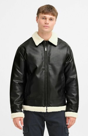 Black leather jacket with a shearling collar and cuffs, featuring a front zipper and smooth texture. Waist-length with side pockets.