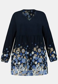 Námořnický dlouhý rukáv s výstřihem do V; stahovaný pas a květinový vzor v modré, krémové a zlaté. Měkká látka s elastickými manžetami na rukávech.