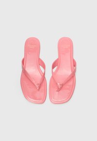 Infradito rosa in gomma con una finitura lucida, caratterizzati da un design minimalista e un piccolo dettaglio floreale in metallo sulle cinghie.