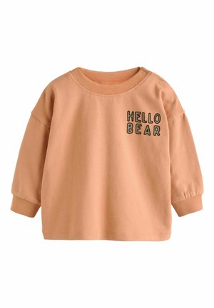 Lys ferskenfarvet sweatshirt i blødt bomuldsblanding med rund halsudskæring og lange, let puffede ærmer. Har broderet "HELLO BEAR" i sort.