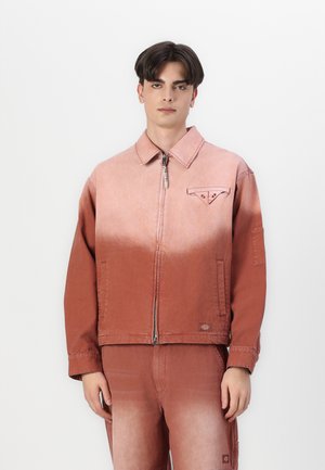 Rose-colored denim jacket featuring a zip closure, collar, patch pocket, and a gradient texture. Paired with matching pants.