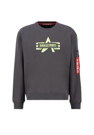 Tumedast hallist kangast dress, millel on fluorestsentselt kollane täht ja "INDUSTRIES" trükk. Sisaldab küljetaskut punase lukuga ja sildi.