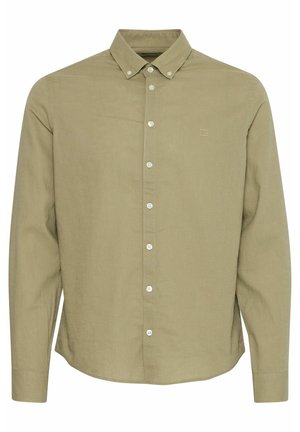 Hele roheline, pika varrukaga nööpidega särk, millel on terav krae. Omab valgeid nööpe ja diskreetset logo rinnal. Tekstuuriga kangas.